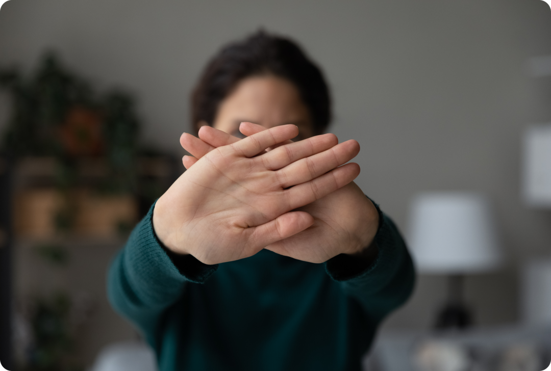 MS: Betroffene berichtet Eine Frau hält beide Hände abwehrend vor ihr Gesicht.